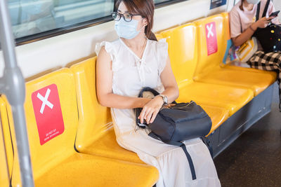 Close-up of woman away sitting in subway train