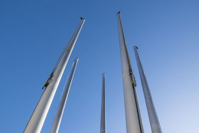 Low angle view of sailboat against clear blue sky