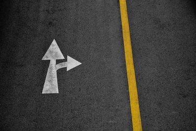 High angle view of arrow sign on road