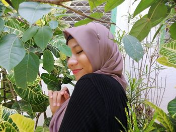 Portrait of woman with plants