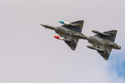 Low angle view of airplane flying against clear sky