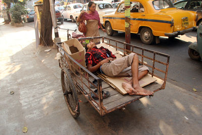 People sleeping on street in city