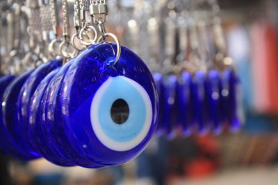 Close-up of key chains hanging for sale in store