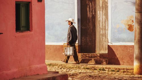 Full length of man standing against building