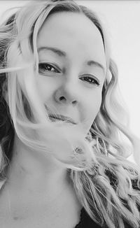 Close-up portrait of beautiful young woman over white background