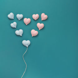 High angle view of heart shape on blue table