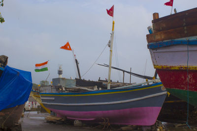Boats moored on sea against sky
