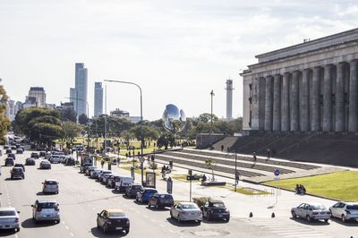 Traffic on road in city against sky