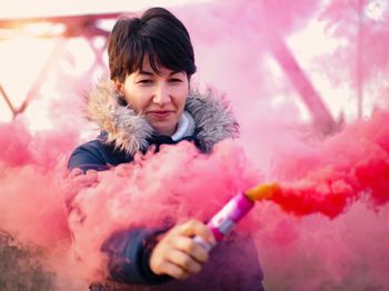 Smiling woman holding distress flare