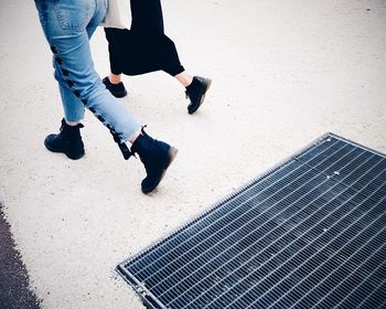 Low section of woman walking on street