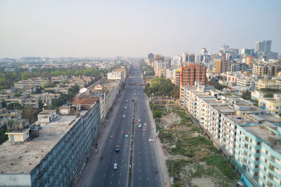 High angle view of street amidst buildings against sky