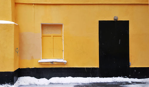 Close-up of yellow window of building