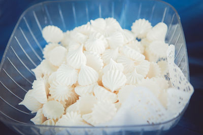 Closeup shot of white fresh tender marshmallow zephyr in a glass plastic bowl dish on table