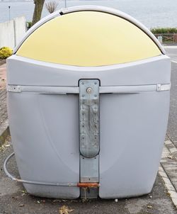 Close-up of deck chairs on sidewalk