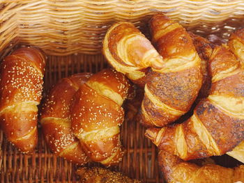 Directly above shot of croissants in basket for sale at bakery