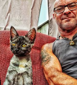 Portrait of cat with man