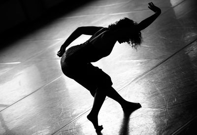 Silhouette man dancing on wall