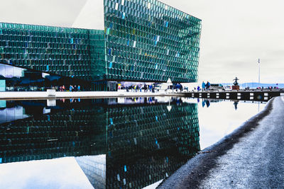 Reflection of building in city against sky