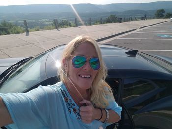 Portrait of smiling young woman in car