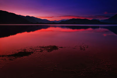 Scenic view of lake against romantic sky at sunset