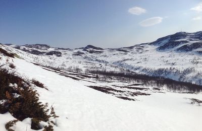 Scenic view of snow covered mountains against sky