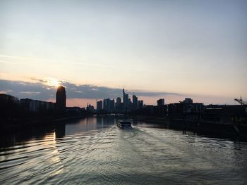 View of city at waterfront during sunset