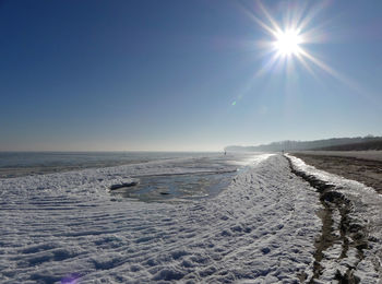 Scenic view of sea against clear sky during winter