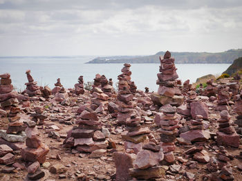 Rocks on sea shore against sky