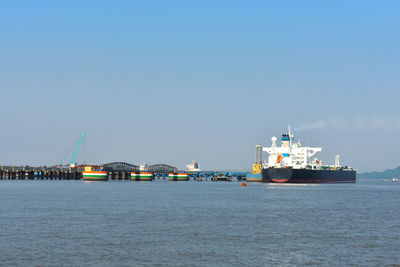 Ship sailing in sea against clear sky