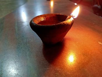 Close-up of lit candles on table