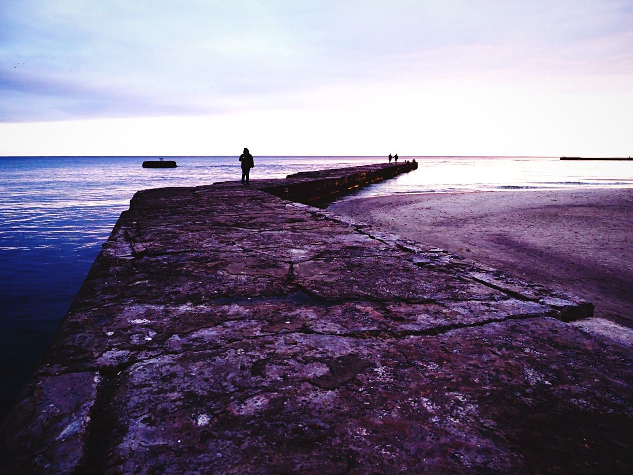 sea, water, horizon over water, nature, tranquil scene, one person, scenics, sky, tranquility, fishing, full length, silhouette, beauty in nature, rock - object, outdoors, leisure activity, real people, fishing pole, standing, day, men, people