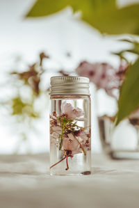 Close-up of essential oil and flowers on table