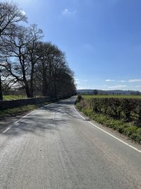 Empty road along countryside landscape