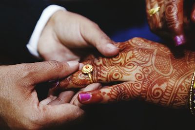 Close-up of human hands with henna tattoo