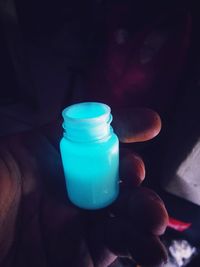 Close-up of hand holding glass bottle