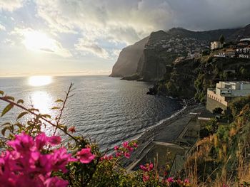 Scenic view of sea and mountains against sky