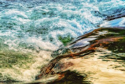 High angle view of water flowing through rocks