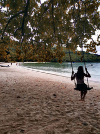 Rear view of man walking on beach