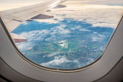 Aerial view of landscape seen through airplane window 