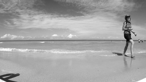 Man standing on beach against sky