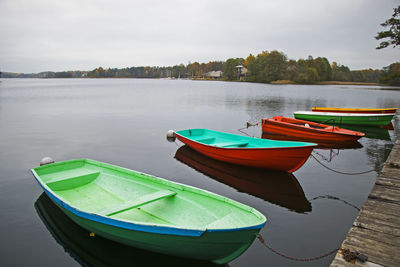 Old wooden boats near the beach of trakai gavle lake, lithuania. autumn and fall time.