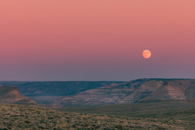 Scenic view of landscape against sky during sunset