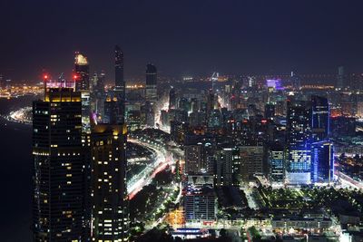 Aerial view of city lit up at night