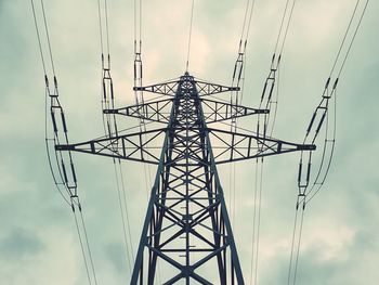 Low angle view of electricity pylon against sky