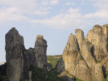 Low angle view of mountains against cloudy sky