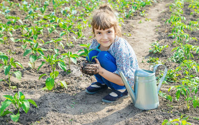 Portrait of cute girl playing with plants