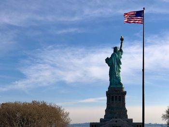 The statue of liberty with american flag, new york city 