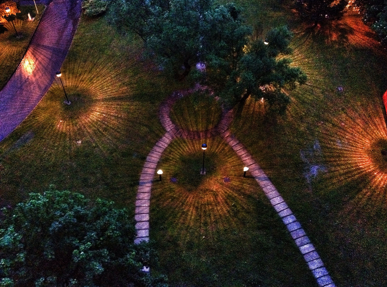 high angle view, road, street, outdoors, transportation, tree, no people, multi colored, road marking, the way forward, illuminated, art, day, asphalt, pattern, shadow, creativity, close-up, art and craft