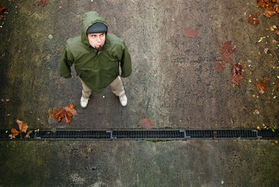 High angle view of mid adult man looking away while standing on street during autumn