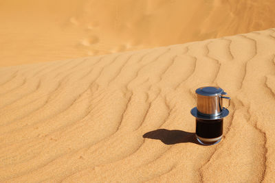 High angle view of tea on sand at beach